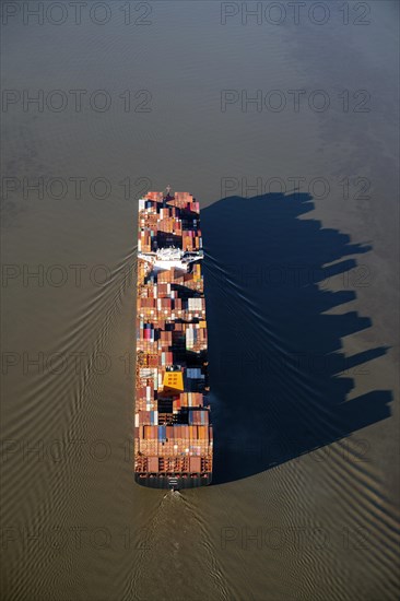 Container ships in the shipping channel of the Elbe