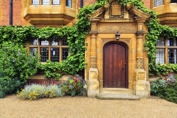 Door with ornate columns and flowering plants