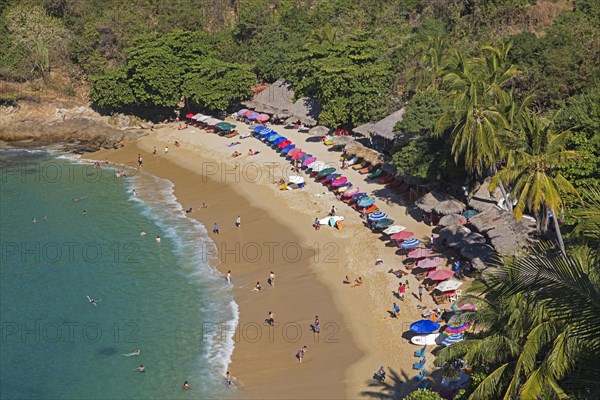 Tourists sunning and swimming at Playa Carrizalillo