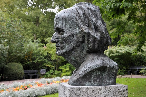 Bust of the surrealist painter Paul Delvaux in city park at Veurne