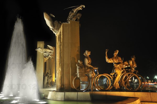 Sculpture group with fountain at night