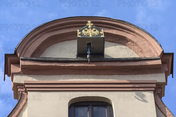 Crane winch decorated with the double-headed eagle on a historic gabled house