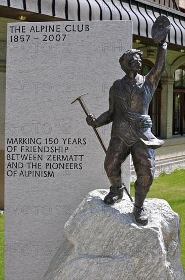 Statue of mountain guide of the British Alpine Club in alpine village Zermatt