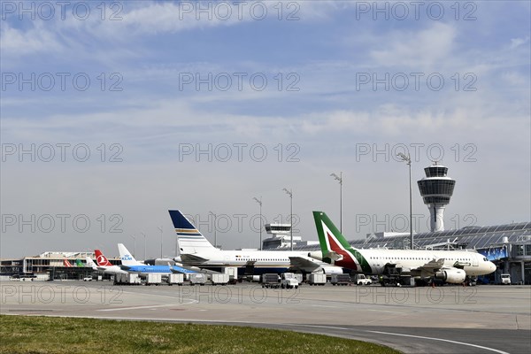 Aircraft on check-in position at Terminal 1 with tower