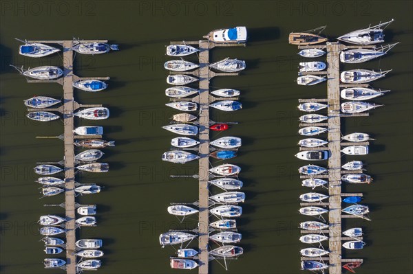 Aerial view over berthing jetty with sailing boats at marina in harbour of the city Stralsund along the Strelasund