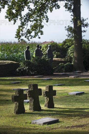 Sculpture group Trauernde Soldaten by Emil Krieger and German graves at the First World War One military cemetery Deutscher Soldatenfriedhof Langemark