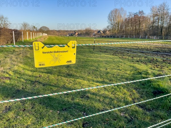 Warning sign on electric fence in wolf area Schermbeck