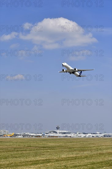 Lufthansa Airbus A350-900 taking off on runway south with tower