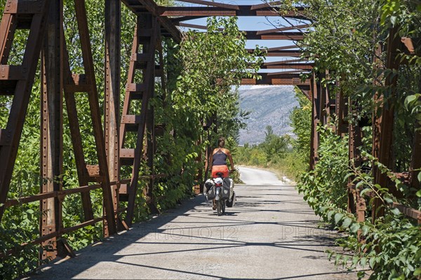 Cycling over old bridge on the Ciro Trail