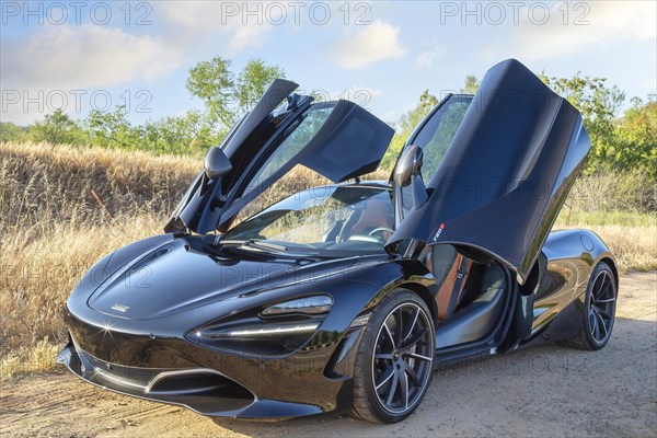 A black McLaren 720S with open doors