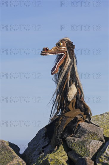 Scary wooden devil figure on the summit of Mount Lusen in autumn