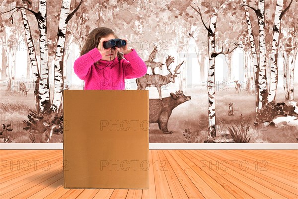 Child sitting in a box and looking through binoculars