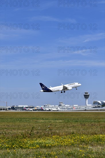 Lufthansa Airbus A320-200 taking off on runway south with tower