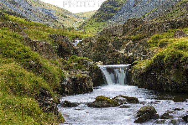 A small waterfall running alongside the road