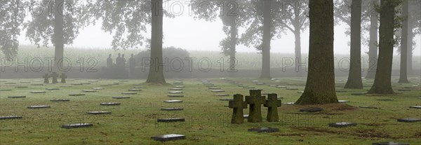 Sculpture group Trauernde Soldaten by Emil Krieger and German graves at the First World War One military cemetery Deutscher Soldatenfriedhof Langemark