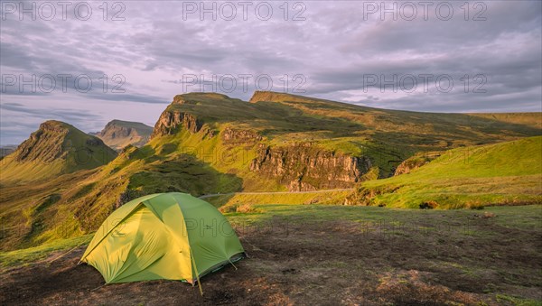 Tent overlooking rocky landscape Quiraing at sunrise