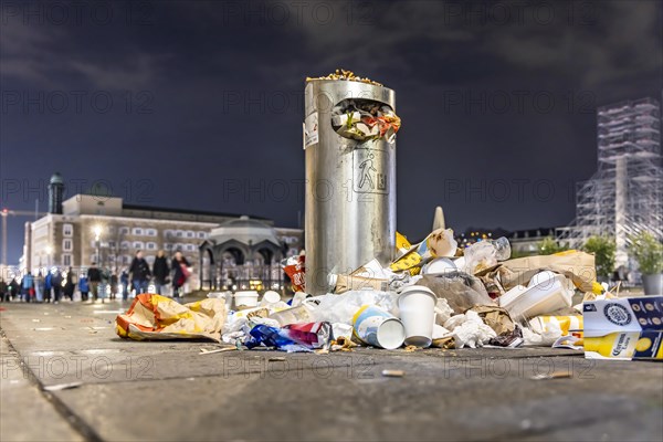 Full waste bins with packaging waste and cigarette butts