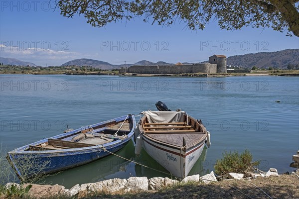 Fishing boats and 15th century Venetian Triangular Castle along the Vivari Channel near Butrint National Park