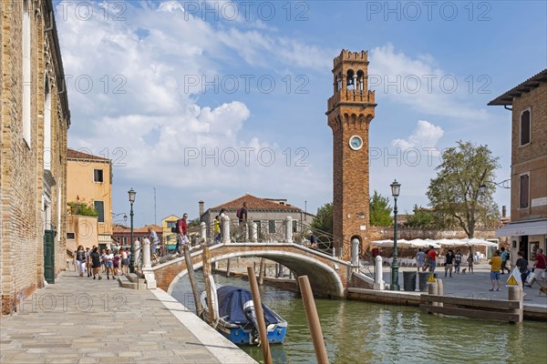 Clock tower and Ponte San Pietro Martire bridge over canal Rio dei Vetrai at Murano