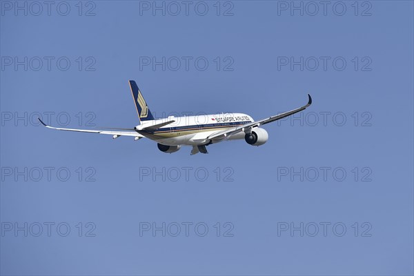 Singapore Airlines Airbus A350-900 taking off on runway south with tower