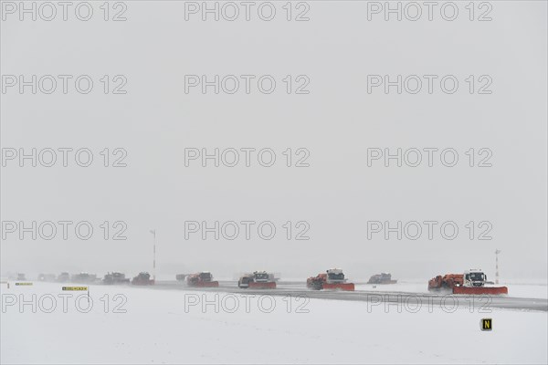Road sweepers and snow ploughs clear snow on the taxiways and Runway North