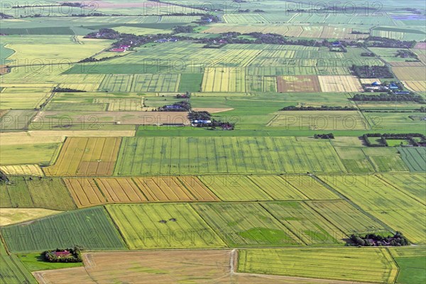 Aerial view over farmland showing tractor tracks in agricultural parcels