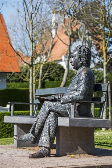 Albert Einstein statue sitting on a park bench at the seaside resort De Haan