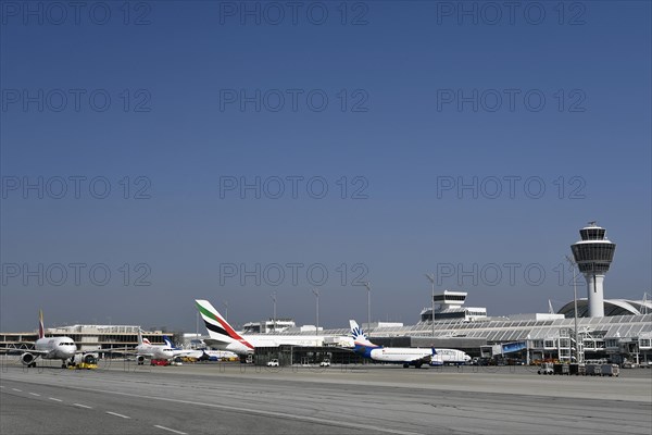Iberia Airbus with Sunexpress Boeing B737 and Emirates Airbus A380-800 in front of Terminal 1 with Tower