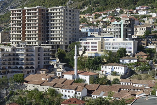 Roofs of the bazaar with minaret in front of modern high-rise buildings