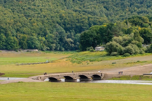 During drought from reservoir Edersee exposed historical bridge over river Eder near village Asel