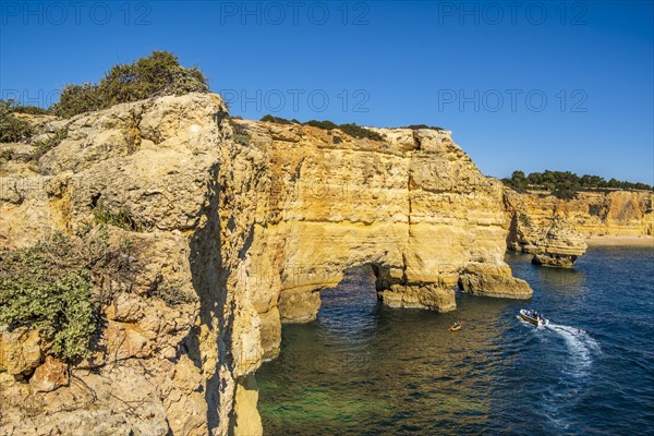 Beautiful cliffs and rock formations by the Atlantic Ocean at Marinha Beach in Algarve, Portugal, Europe