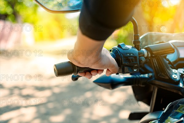 Hands of a motorcyclist on the handlebars, Close up of the hands on the handlebars of a motorcycle. Hands of a person on the motorcycle handlebars. Motorbike speeding concept