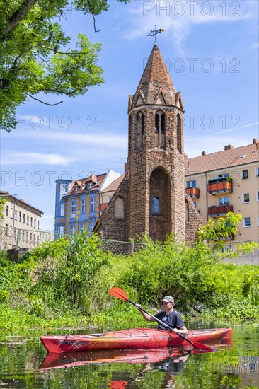 Paddler in a kayak on the Jakobskanal, Jakobskapelle in the back, Brandenburg an der Havel, Brandenburg, Germany, Europe