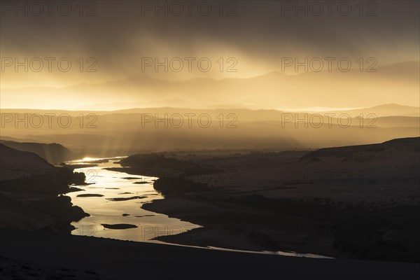 Thunderstorm over the Orange River, also known as the Orange River, on the border between Namibia and South Africa, Oranjemund, Sperrgebiet National Park, also known as Tsau ÇKhaeb National Park, Namibia, Africa