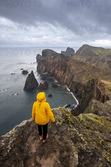 Hiker, coastal landscape, cliffs and sea, Miradouro da Ponta do Rosto, rugged coastline with rock formations, Cape Ponta de Sao Lourenco, Madeira, Portugal, Europe