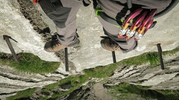 Passage via ferrata with a large exposure and an amazing view down. Zugspitze massif in the bavarian alps, Dolomites, Italy, Europe