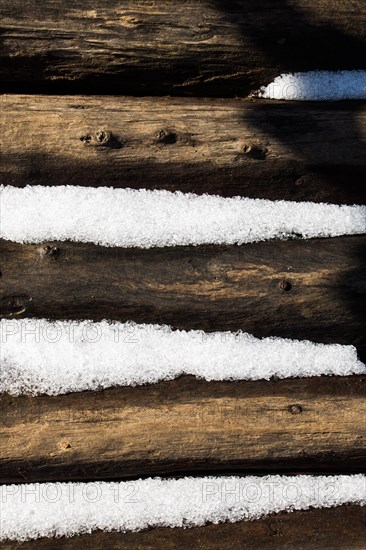 Snow winter background with some snow on wood