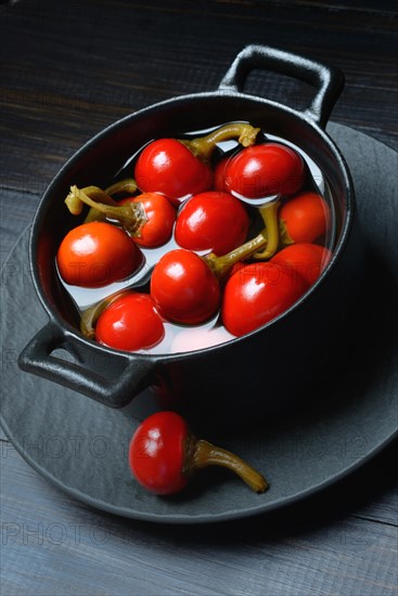 Potted cherry peppers in vinegar, chilli, paprika