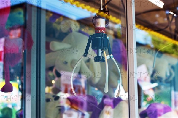 Heidelberg, Germany, May 23rd 2019: Close up of claw crane machine behind glass at funfair as part of Festival of German-American Friendship in Heidelberg, Europe