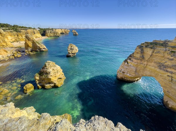 Beautiful cliffs and rock formations by the Atlantic Ocean at Marinha Beach in Algarve, Portugal, Europe