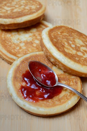Pancake with raspberry jam and spoon