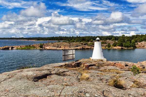 Coastline with lighthouse on rocks, sunny weather, Kaeringsund, Fasta Aland, Aland Islands, Aland Islands, Finland, Europe