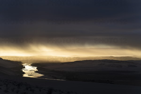 Thunderstorm over the Orange River, also known as the Orange River, on the border between Namibia and South Africa, Oranjemund, Sperrgebiet National Park, also known as Tsau ÇKhaeb National Park, Namibia, Africa