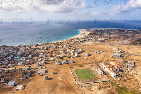 Wide aerial view on Santa Maria with the resorts on the right, African village to the left and sports field in the middle, Sal, Cape Verde Islands, Africa