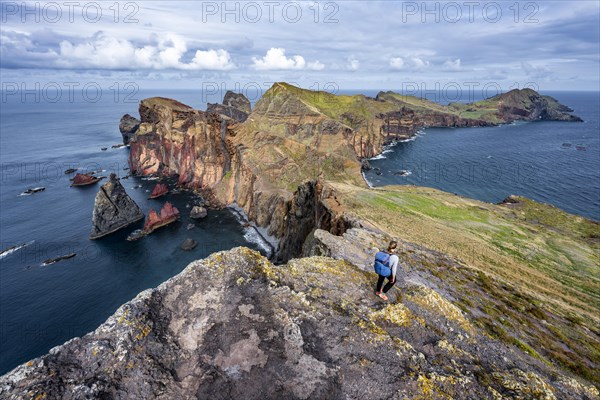 Hiker, coastal landscape, cliffs and sea, Miradouro da Ponta do Rosto, rugged coastline with rock formations, Cape Ponta de Sao Lourenco, Madeira, Portugal, Europe