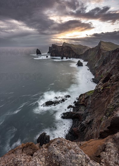 Red cliffs and rocks in the sea, coastal landscape, long exposure at sunset, Miradouro do Canical, Ponta de Sao Lourenco, volcanic peninsula Sao Lourenco, Ponta de San Lorenzo, Madeira, Portugal, Europe