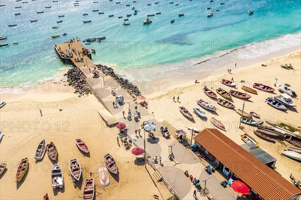 Pier and boats on turquoise water in city of Santa Maria, island of Sal, Cape Verde, Africa