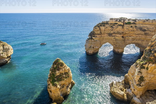 Beautiful cliffs and rock formations by the Atlantic Ocean at Marinha Beach in Algarve, Portugal, Europe