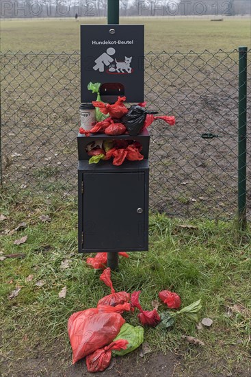 Overcrowded collection point for dog excrement bags in front of a dog playground, Bavaria, Germany, Europe
