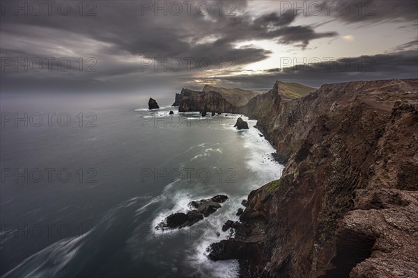 Red cliffs and rocks in the sea, coastal landscape, long exposure at sunset, Miradouro do Canical, Ponta de Sao Lourenco, volcanic peninsula Sao Lourenco, Ponta de San Lorenzo, Madeira, Portugal, Europe